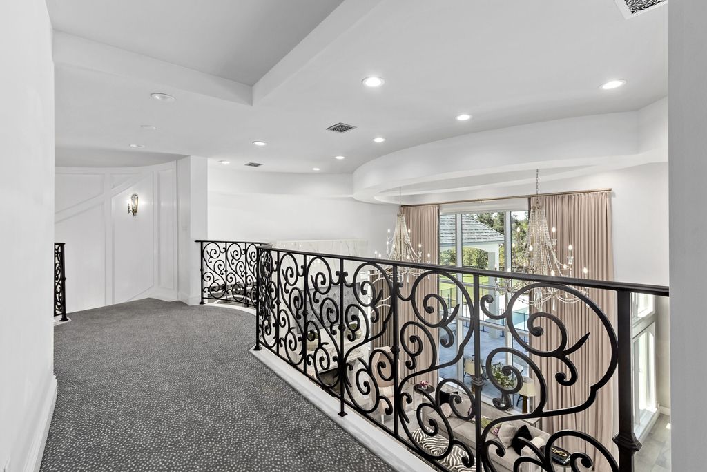 The Home in Bryan, a luxurious custom residence has a open concept great room complete with 20-foot ceilings, a beautifully designed pool and elegant outdoor entertaining area. This home located at 7163 Riverstone Dr, Bryan, Texas.