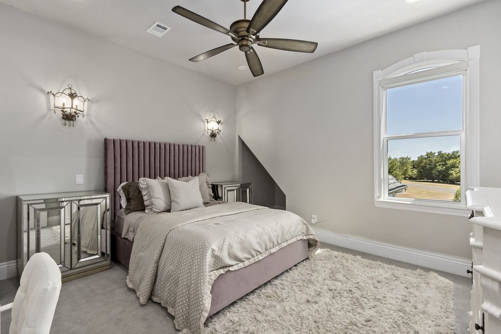 The Home in Bryan, a luxurious custom residence has a open concept great room complete with 20-foot ceilings, a beautifully designed pool and elegant outdoor entertaining area. This home located at 7163 Riverstone Dr, Bryan, Texas.