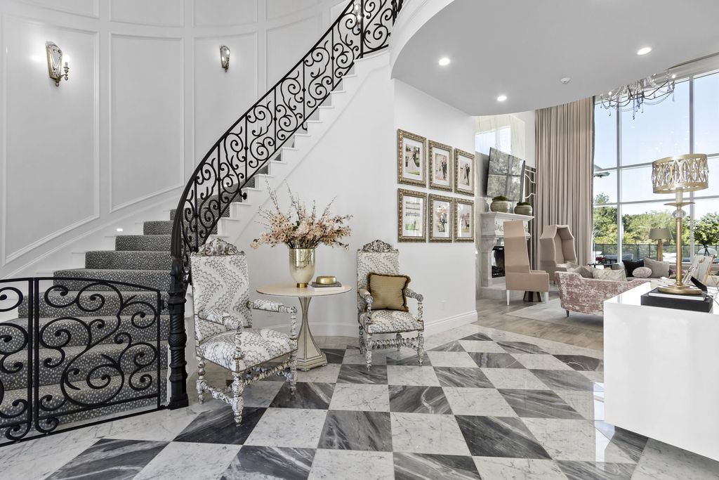 The Home in Bryan, a luxurious custom residence has a open concept great room complete with 20-foot ceilings, a beautifully designed pool and elegant outdoor entertaining area. This home located at 7163 Riverstone Dr, Bryan, Texas.