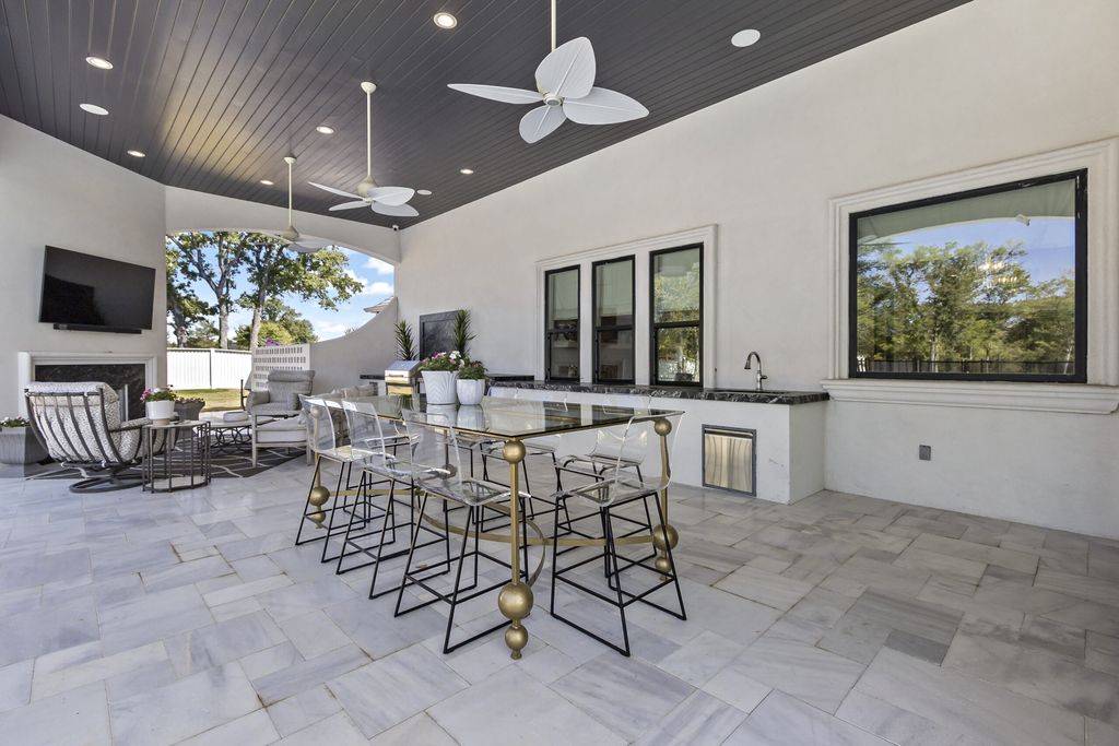 The Home in Bryan, a luxurious custom residence has a open concept great room complete with 20-foot ceilings, a beautifully designed pool and elegant outdoor entertaining area. This home located at 7163 Riverstone Dr, Bryan, Texas.