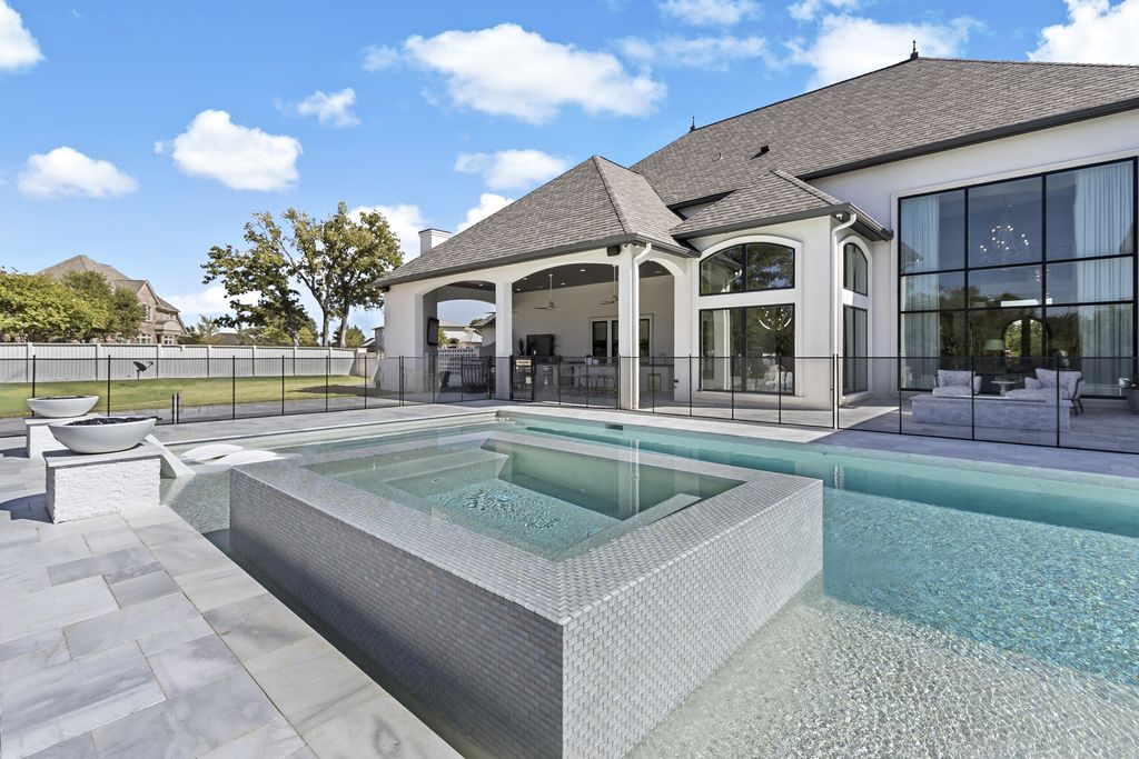 The Home in Bryan, a luxurious custom residence has a open concept great room complete with 20-foot ceilings, a beautifully designed pool and elegant outdoor entertaining area. This home located at 7163 Riverstone Dr, Bryan, Texas.