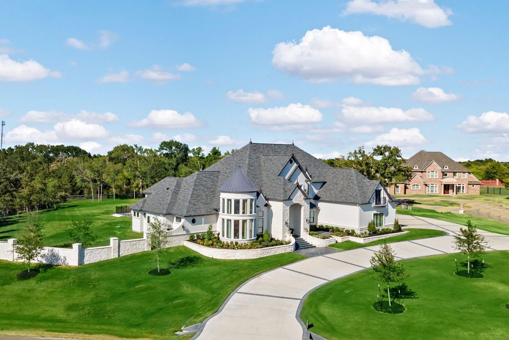 The Home in Bryan, a luxurious custom residence has a open concept great room complete with 20-foot ceilings, a beautifully designed pool and elegant outdoor entertaining area. This home located at 7163 Riverstone Dr, Bryan, Texas.