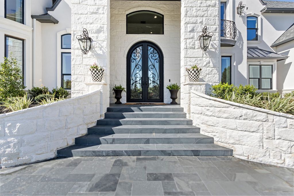 The Home in Bryan, a luxurious custom residence has a open concept great room complete with 20-foot ceilings, a beautifully designed pool and elegant outdoor entertaining area. This home located at 7163 Riverstone Dr, Bryan, Texas.