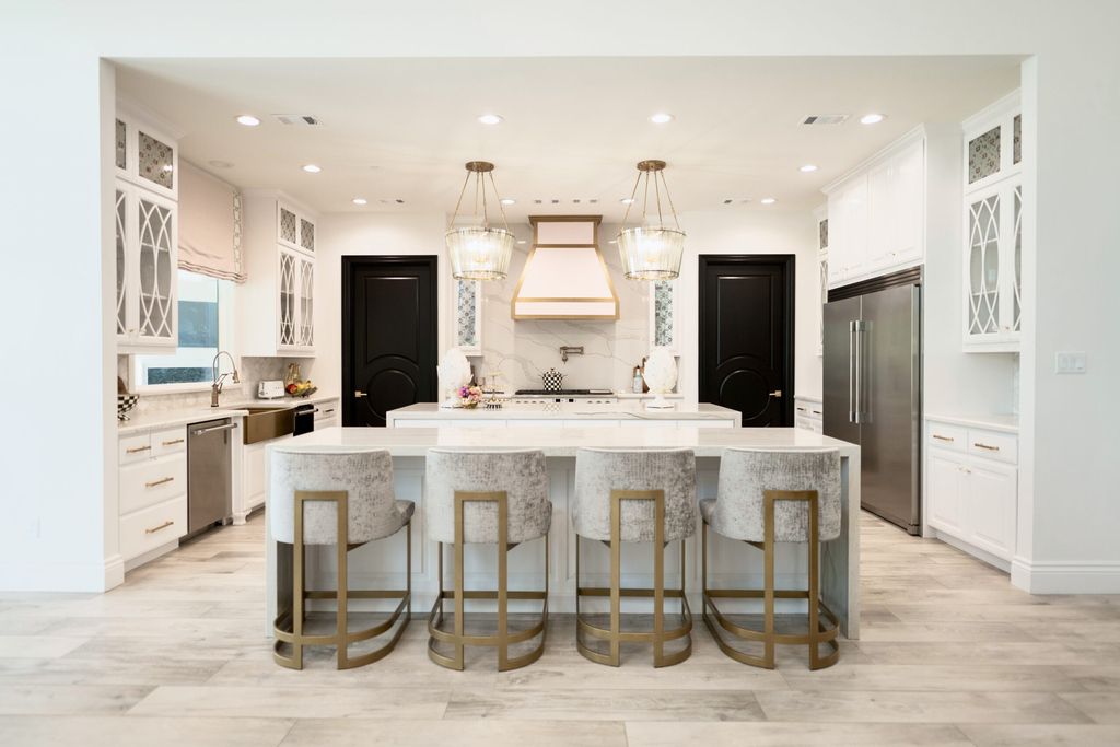 The Home in Bryan, a luxurious custom residence has a open concept great room complete with 20-foot ceilings, a beautifully designed pool and elegant outdoor entertaining area. This home located at 7163 Riverstone Dr, Bryan, Texas.