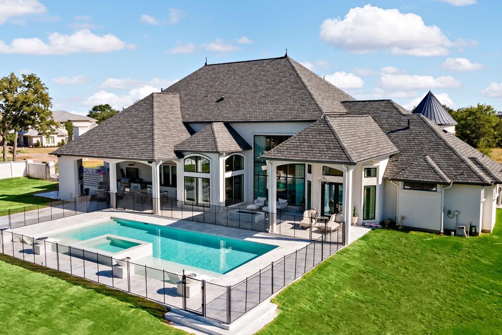 The Home in Bryan, a luxurious custom residence has a open concept great room complete with 20-foot ceilings, a beautifully designed pool and elegant outdoor entertaining area. This home located at 7163 Riverstone Dr, Bryan, Texas.