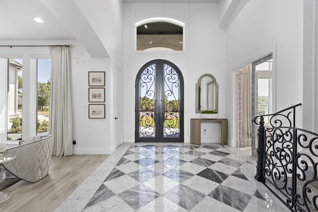 The Home in Bryan, a luxurious custom residence has a open concept great room complete with 20-foot ceilings, a beautifully designed pool and elegant outdoor entertaining area. This home located at 7163 Riverstone Dr, Bryan, Texas.