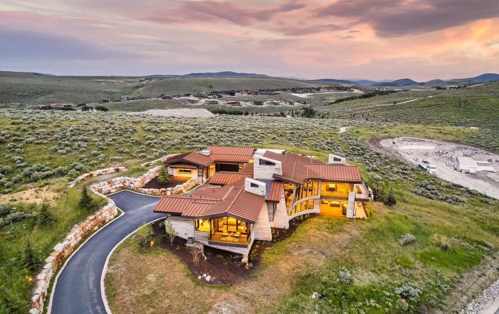 The Masterpiece in Park City, an amazing Upwall Design home showcases the stunning views, the majestic expanse of the main hallway, the seamless marriage of wood, stone and glass. This home located at 7400 Bugle Trl, Park City, Utah.