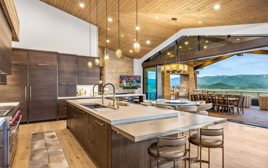 The Masterpiece in Park City, an amazing Upwall Design home showcases the stunning views, the majestic expanse of the main hallway, the seamless marriage of wood, stone and glass. This home located at 7400 Bugle Trl, Park City, Utah.