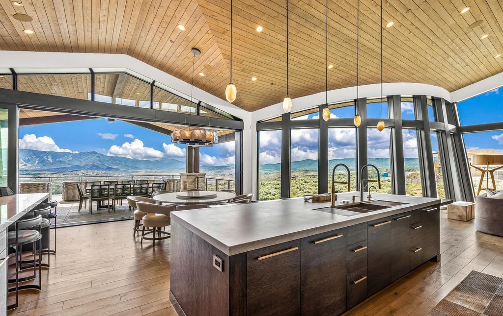 The Masterpiece in Park City, an amazing Upwall Design home showcases the stunning views, the majestic expanse of the main hallway, the seamless marriage of wood, stone and glass. This home located at 7400 Bugle Trl, Park City, Utah.