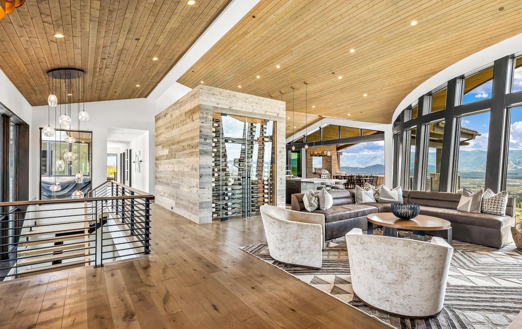 The Masterpiece in Park City, an amazing Upwall Design home showcases the stunning views, the majestic expanse of the main hallway, the seamless marriage of wood, stone and glass. This home located at 7400 Bugle Trl, Park City, Utah.