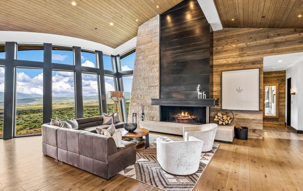 The Masterpiece in Park City, an amazing Upwall Design home showcases the stunning views, the majestic expanse of the main hallway, the seamless marriage of wood, stone and glass. This home located at 7400 Bugle Trl, Park City, Utah.