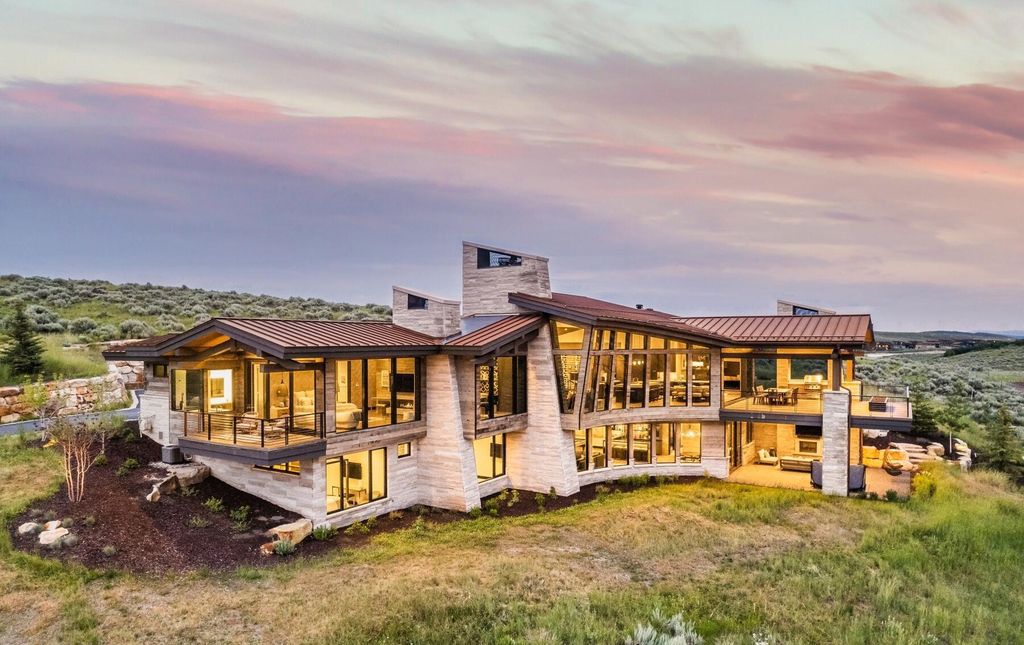 The Masterpiece in Park City, an amazing Upwall Design home showcases the stunning views, the majestic expanse of the main hallway, the seamless marriage of wood, stone and glass. This home located at 7400 Bugle Trl, Park City, Utah.