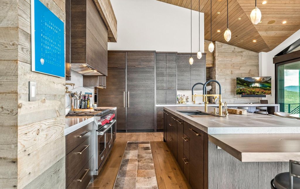 The Masterpiece in Park City, an amazing Upwall Design home showcases the stunning views, the majestic expanse of the main hallway, the seamless marriage of wood, stone and glass. This home located at 7400 Bugle Trl, Park City, Utah.