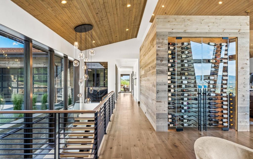 The Masterpiece in Park City, an amazing Upwall Design home showcases the stunning views, the majestic expanse of the main hallway, the seamless marriage of wood, stone and glass. This home located at 7400 Bugle Trl, Park City, Utah.