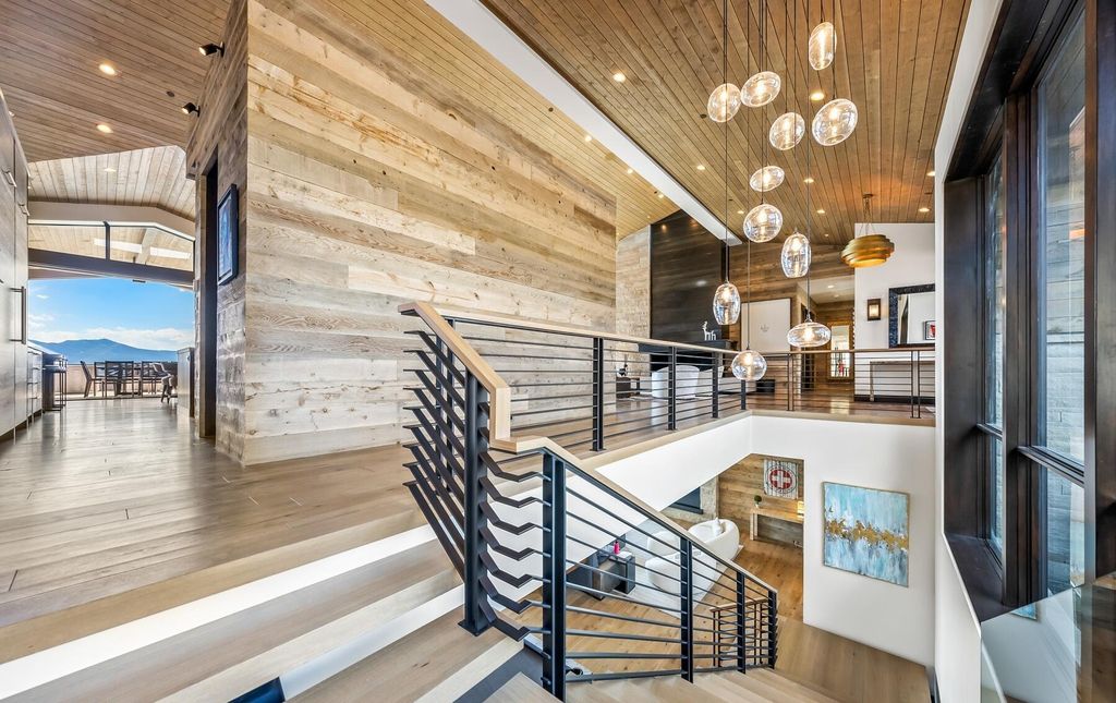 The Masterpiece in Park City, an amazing Upwall Design home showcases the stunning views, the majestic expanse of the main hallway, the seamless marriage of wood, stone and glass. This home located at 7400 Bugle Trl, Park City, Utah.