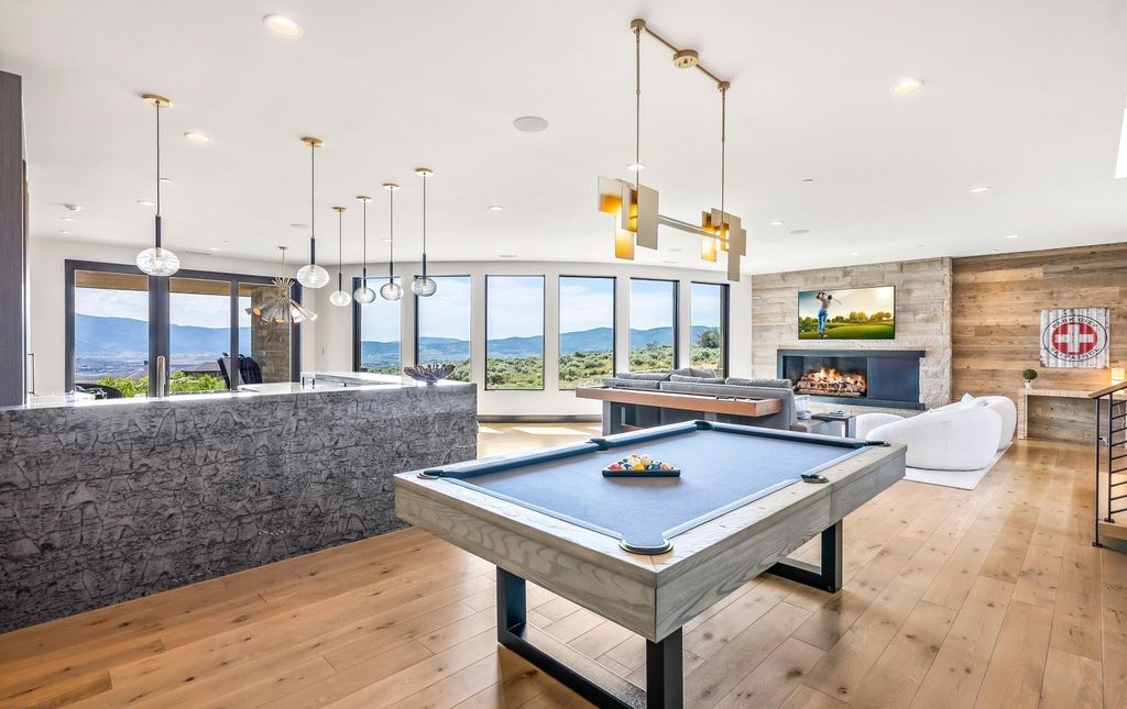 The Masterpiece in Park City, an amazing Upwall Design home showcases the stunning views, the majestic expanse of the main hallway, the seamless marriage of wood, stone and glass. This home located at 7400 Bugle Trl, Park City, Utah.