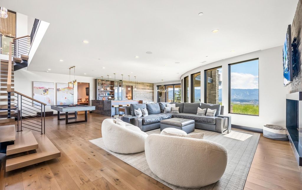 The Masterpiece in Park City, an amazing Upwall Design home showcases the stunning views, the majestic expanse of the main hallway, the seamless marriage of wood, stone and glass. This home located at 7400 Bugle Trl, Park City, Utah.
