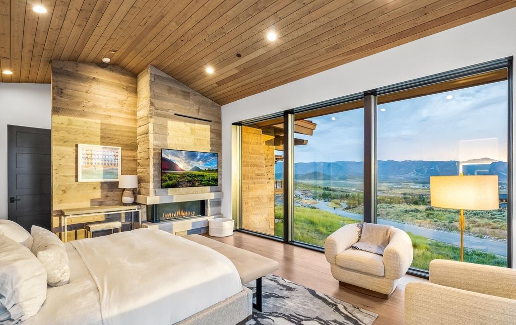 The Masterpiece in Park City, an amazing Upwall Design home showcases the stunning views, the majestic expanse of the main hallway, the seamless marriage of wood, stone and glass. This home located at 7400 Bugle Trl, Park City, Utah.