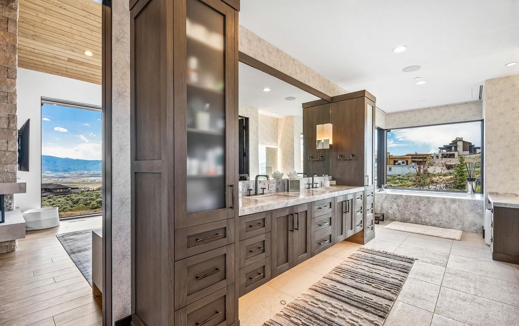The Masterpiece in Park City, an amazing Upwall Design home showcases the stunning views, the majestic expanse of the main hallway, the seamless marriage of wood, stone and glass. This home located at 7400 Bugle Trl, Park City, Utah.