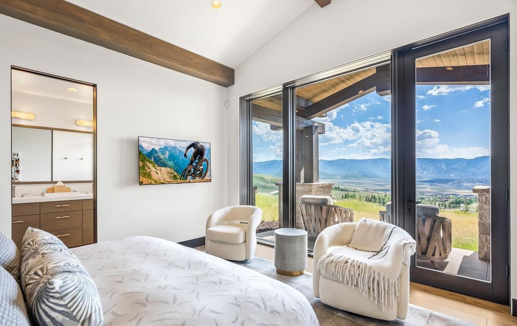 The Masterpiece in Park City, an amazing Upwall Design home showcases the stunning views, the majestic expanse of the main hallway, the seamless marriage of wood, stone and glass. This home located at 7400 Bugle Trl, Park City, Utah.