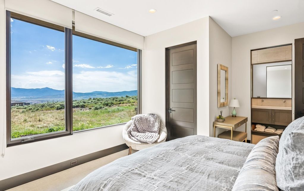 The Masterpiece in Park City, an amazing Upwall Design home showcases the stunning views, the majestic expanse of the main hallway, the seamless marriage of wood, stone and glass. This home located at 7400 Bugle Trl, Park City, Utah.