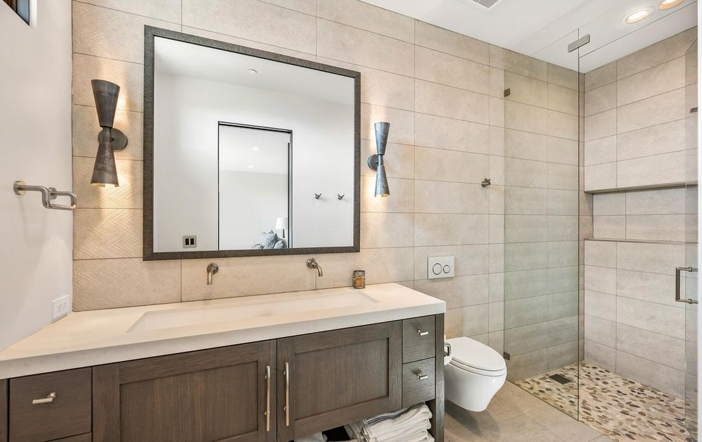 The Masterpiece in Park City, an amazing Upwall Design home showcases the stunning views, the majestic expanse of the main hallway, the seamless marriage of wood, stone and glass. This home located at 7400 Bugle Trl, Park City, Utah.