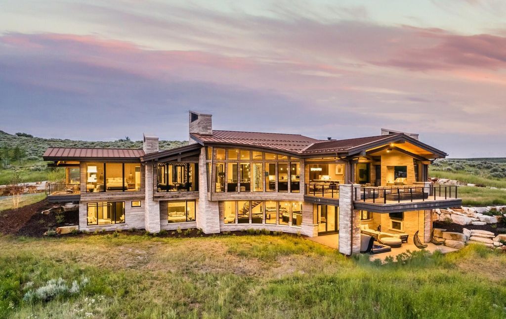 The Masterpiece in Park City, an amazing Upwall Design home showcases the stunning views, the majestic expanse of the main hallway, the seamless marriage of wood, stone and glass. This home located at 7400 Bugle Trl, Park City, Utah.
