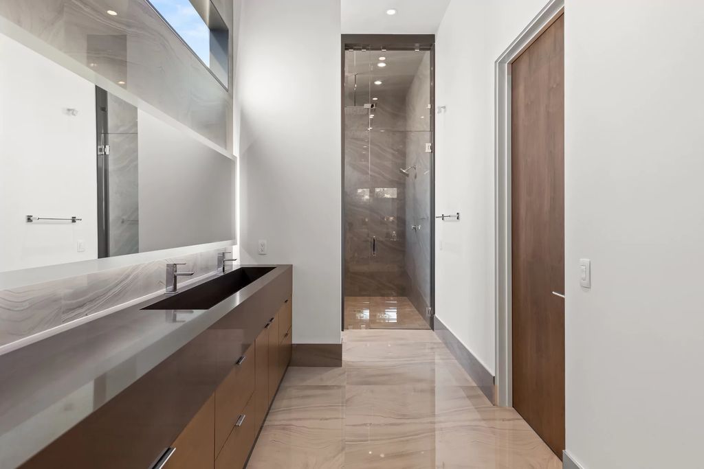 The Masterpiece in Las Vegas, a stunning contemporary home majestically perched within the prestigious guard-gated Spanish Hills offering some of the best Las Vegas Strip views. This home located at 5198 Scenic Ridge Dr, Las Vegas, Nevada.