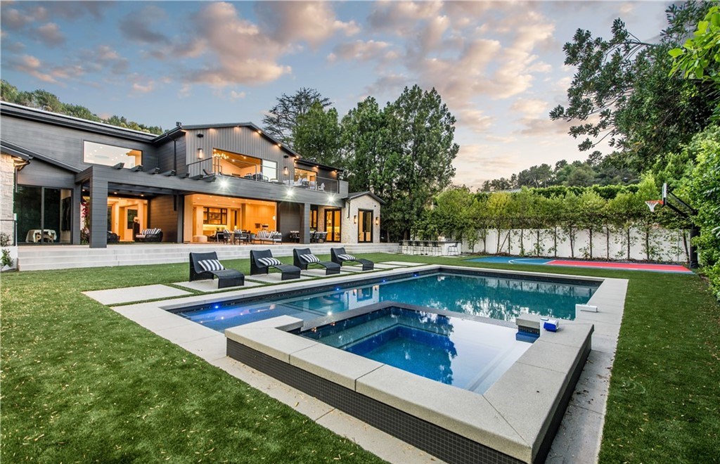 The Farmhouse in Encino, Exquisite new construction gated estate in the coveted enclave of Royal Oaks neighborhood with the sprawling grounds featuring a sparkling pool & spa, sports court, spacious elevated patio, grass area. This home located at 15825 Woodvale Rd, Encino, California