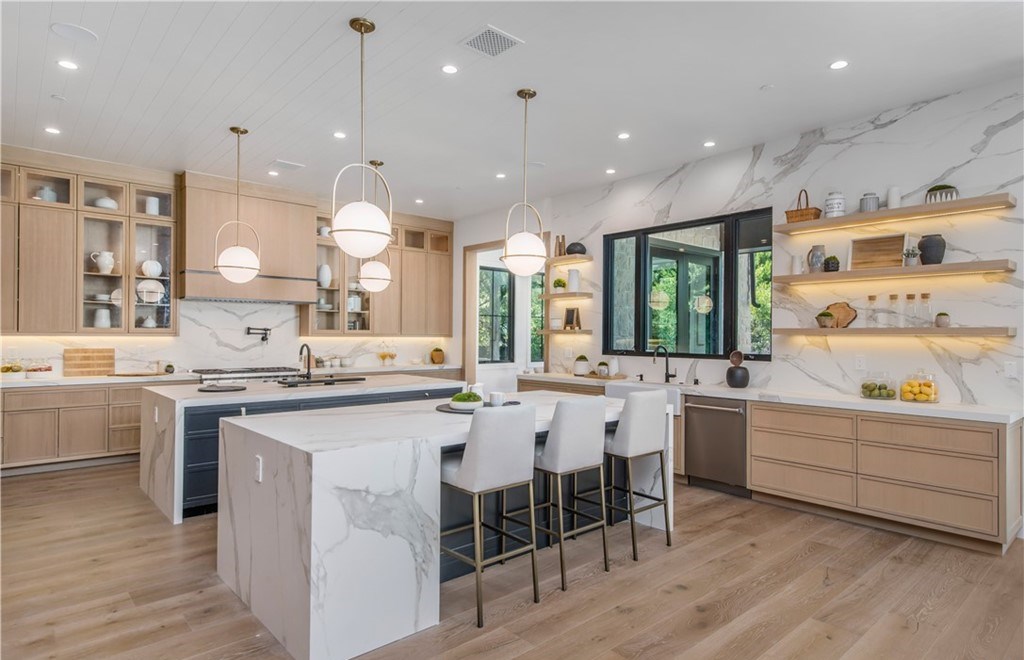 The Farmhouse in Encino, Exquisite new construction gated estate in the coveted enclave of Royal Oaks neighborhood with the sprawling grounds featuring a sparkling pool & spa, sports court, spacious elevated patio, grass area. This home located at 15825 Woodvale Rd, Encino, California