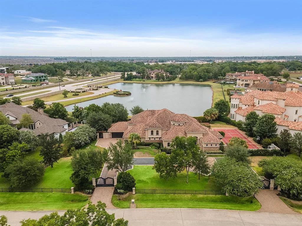 The Estate in Richmond, a private oasis nestled within The Retreat at Sovereign Shores offers resort style with a lavish swimming pool, tennis court, multiple outdoor patios is now available for sale. This home located at 12 Retreat Blvd, Richmond, Texas 