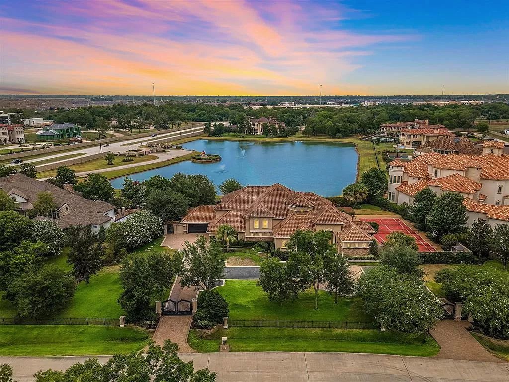 The Estate in Richmond, a private oasis nestled within The Retreat at Sovereign Shores offers resort style with a lavish swimming pool, tennis court, multiple outdoor patios is now available for sale. This home located at 12 Retreat Blvd, Richmond, Texas 