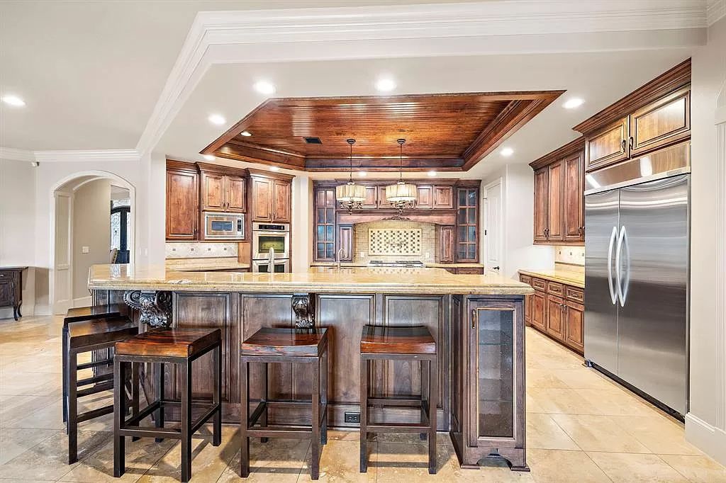 The Estate in Richmond, a private oasis nestled within The Retreat at Sovereign Shores offers resort style with a lavish swimming pool, tennis court, multiple outdoor patios is now available for sale. This home located at 12 Retreat Blvd, Richmond, Texas 