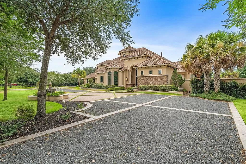 The Estate in Richmond, a private oasis nestled within The Retreat at Sovereign Shores offers resort style with a lavish swimming pool, tennis court, multiple outdoor patios is now available for sale. This home located at 12 Retreat Blvd, Richmond, Texas 