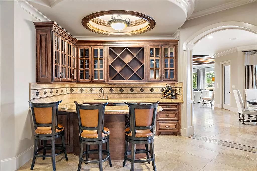 The Estate in Richmond, a private oasis nestled within The Retreat at Sovereign Shores offers resort style with a lavish swimming pool, tennis court, multiple outdoor patios is now available for sale. This home located at 12 Retreat Blvd, Richmond, Texas 