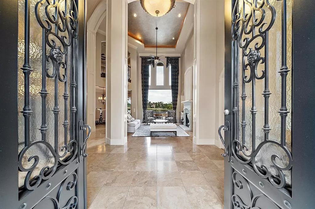 The Estate in Richmond, a private oasis nestled within The Retreat at Sovereign Shores offers resort style with a lavish swimming pool, tennis court, multiple outdoor patios is now available for sale. This home located at 12 Retreat Blvd, Richmond, Texas 