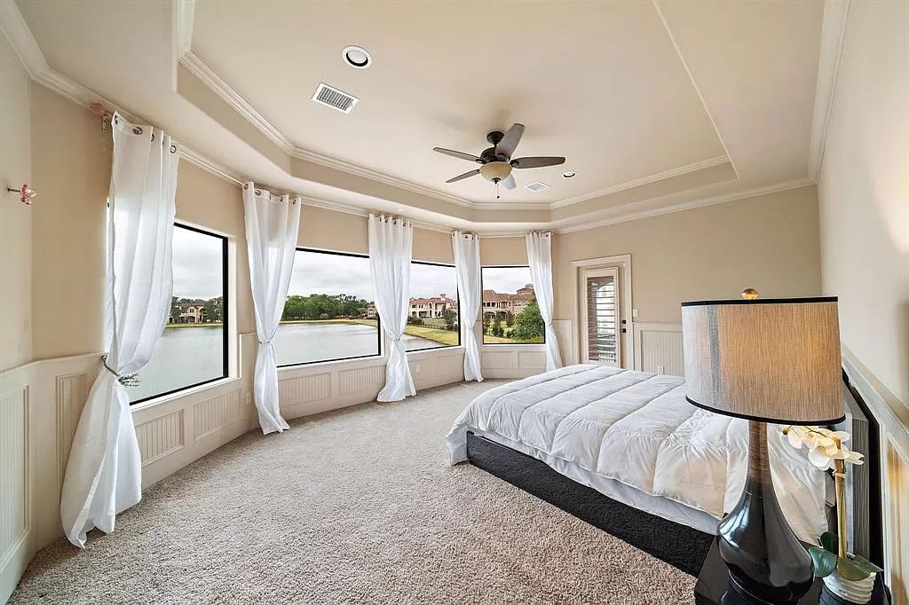 The Estate in Richmond, a private oasis nestled within The Retreat at Sovereign Shores offers resort style with a lavish swimming pool, tennis court, multiple outdoor patios is now available for sale. This home located at 12 Retreat Blvd, Richmond, Texas 