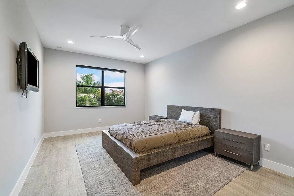 The Home in Boca Raton, a contemporary estate offers notable features include concrete construction, impact glass, custom entry ''pivot'' door, wine storage, theater room  is now available for sale. This home located at 17558 Cadena Dr, Boca Raton, Florida