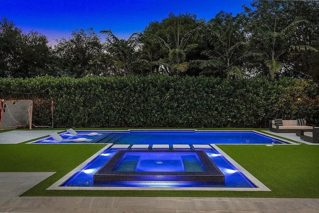 The Home in Boca Raton, a contemporary estate offers notable features include concrete construction, impact glass, custom entry ''pivot'' door, wine storage, theater room  is now available for sale. This home located at 17558 Cadena Dr, Boca Raton, Florida