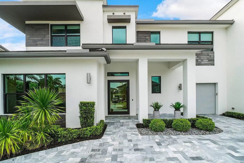 The Home in Boca Raton, a contemporary estate offers notable features include concrete construction, impact glass, custom entry ''pivot'' door, wine storage, theater room  is now available for sale. This home located at 17558 Cadena Dr, Boca Raton, Florida