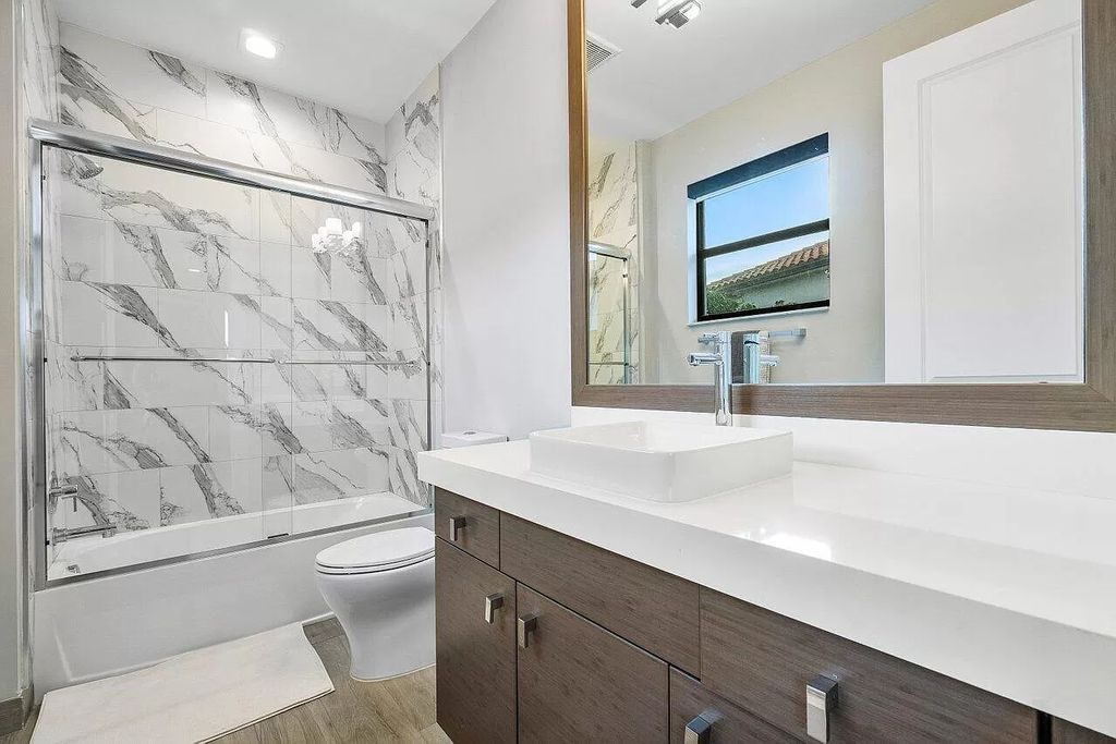 The Home in Boca Raton, a contemporary estate offers notable features include concrete construction, impact glass, custom entry ''pivot'' door, wine storage, theater room  is now available for sale. This home located at 17558 Cadena Dr, Boca Raton, Florida