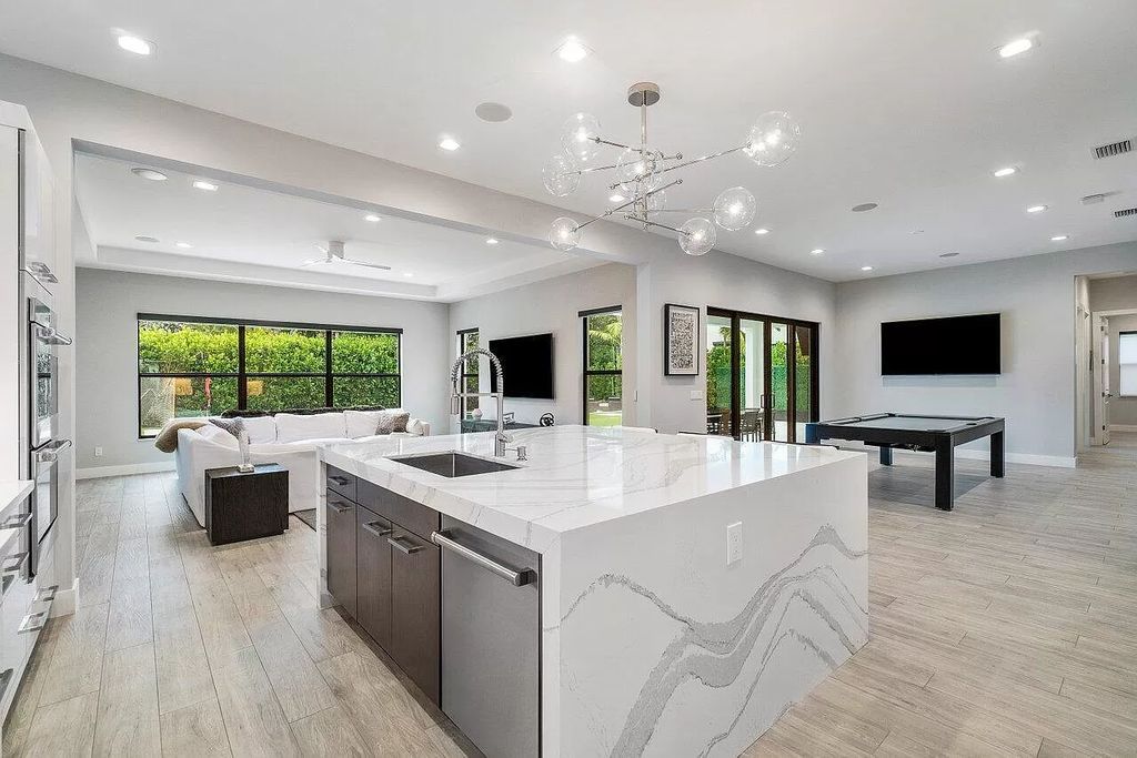 The Home in Boca Raton, a contemporary estate offers notable features include concrete construction, impact glass, custom entry ''pivot'' door, wine storage, theater room  is now available for sale. This home located at 17558 Cadena Dr, Boca Raton, Florida