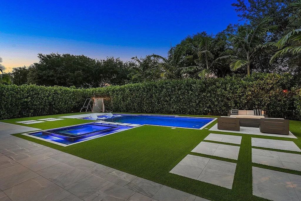 The Home in Boca Raton, a contemporary estate offers notable features include concrete construction, impact glass, custom entry ''pivot'' door, wine storage, theater room  is now available for sale. This home located at 17558 Cadena Dr, Boca Raton, Florida