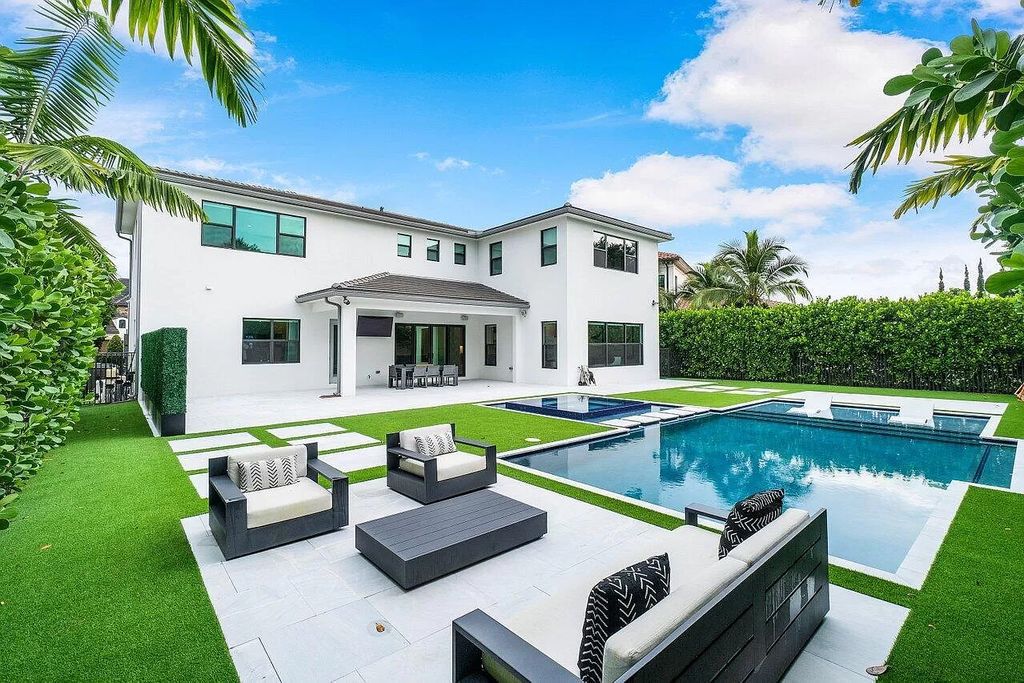 The Home in Boca Raton, a contemporary estate offers notable features include concrete construction, impact glass, custom entry ''pivot'' door, wine storage, theater room  is now available for sale. This home located at 17558 Cadena Dr, Boca Raton, Florida