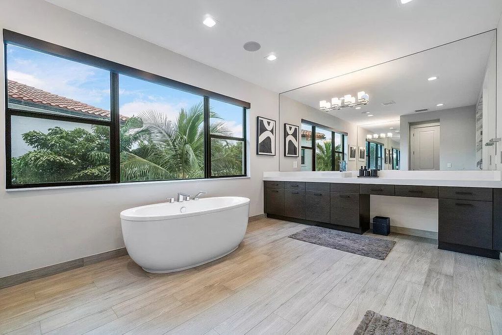 The Home in Boca Raton, a contemporary estate offers notable features include concrete construction, impact glass, custom entry ''pivot'' door, wine storage, theater room  is now available for sale. This home located at 17558 Cadena Dr, Boca Raton, Florida