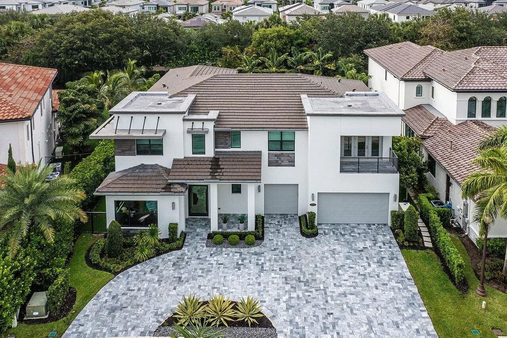 The Home in Boca Raton, a contemporary estate offers notable features include concrete construction, impact glass, custom entry ''pivot'' door, wine storage, theater room  is now available for sale. This home located at 17558 Cadena Dr, Boca Raton, Florida