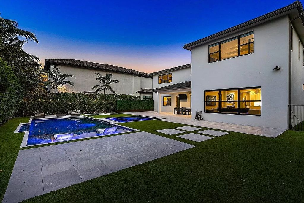 The Home in Boca Raton, a contemporary estate offers notable features include concrete construction, impact glass, custom entry ''pivot'' door, wine storage, theater room  is now available for sale. This home located at 17558 Cadena Dr, Boca Raton, Florida