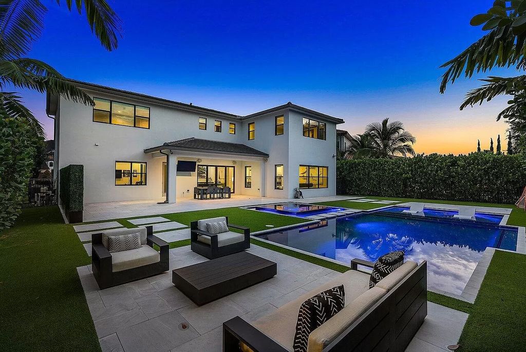 The Home in Boca Raton, a contemporary estate offers notable features include concrete construction, impact glass, custom entry ''pivot'' door, wine storage, theater room  is now available for sale. This home located at 17558 Cadena Dr, Boca Raton, Florida