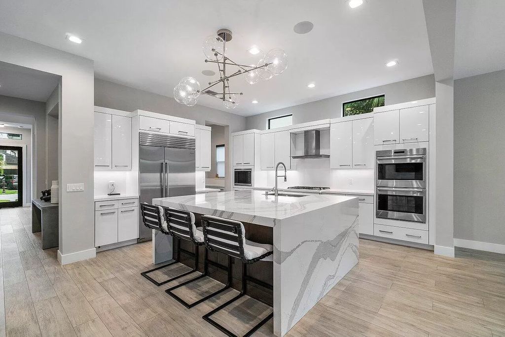 The Home in Boca Raton, a contemporary estate offers notable features include concrete construction, impact glass, custom entry ''pivot'' door, wine storage, theater room  is now available for sale. This home located at 17558 Cadena Dr, Boca Raton, Florida