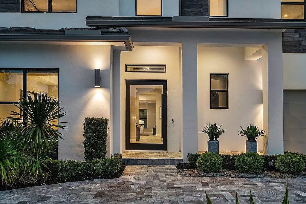 The Home in Boca Raton, a contemporary estate offers notable features include concrete construction, impact glass, custom entry ''pivot'' door, wine storage, theater room  is now available for sale. This home located at 17558 Cadena Dr, Boca Raton, Florida